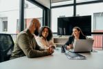 Couple talking to real estate agent in office